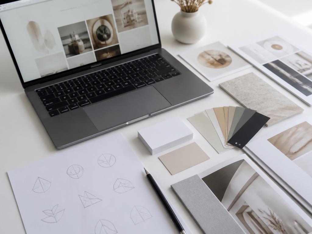 Website and brand design work in progress on a designer's workstation